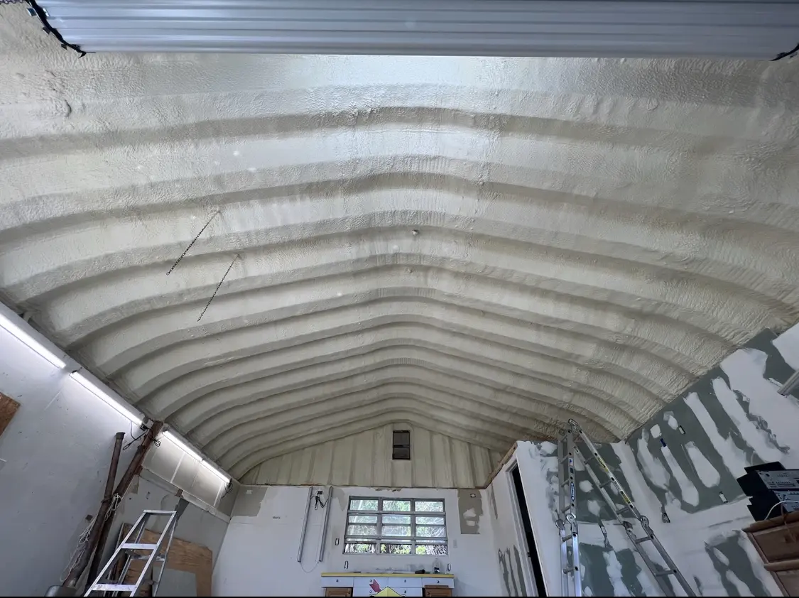 Spray polyurethane foam applied to the underside of a metal roof deck in Alamo